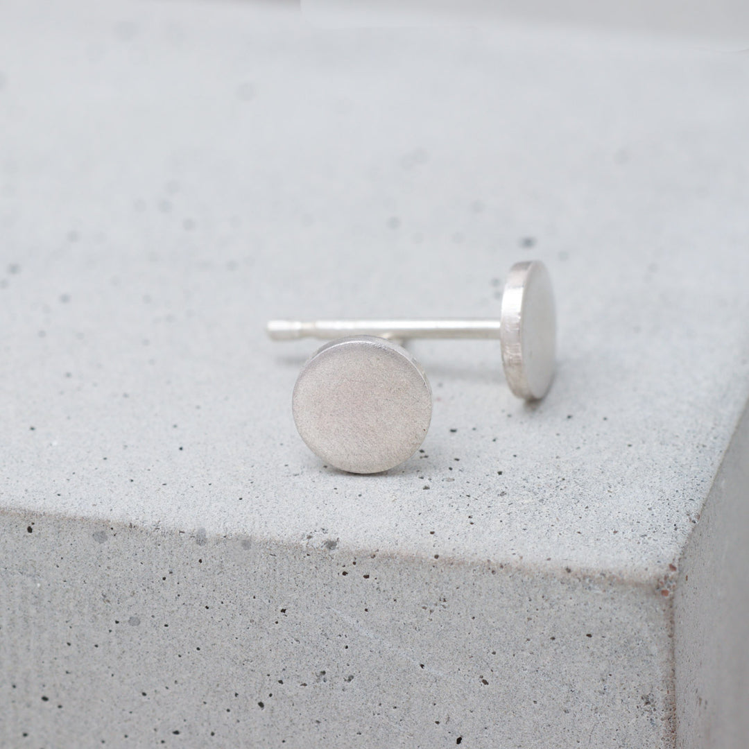 Frosted sterling silver circle stud earrings side