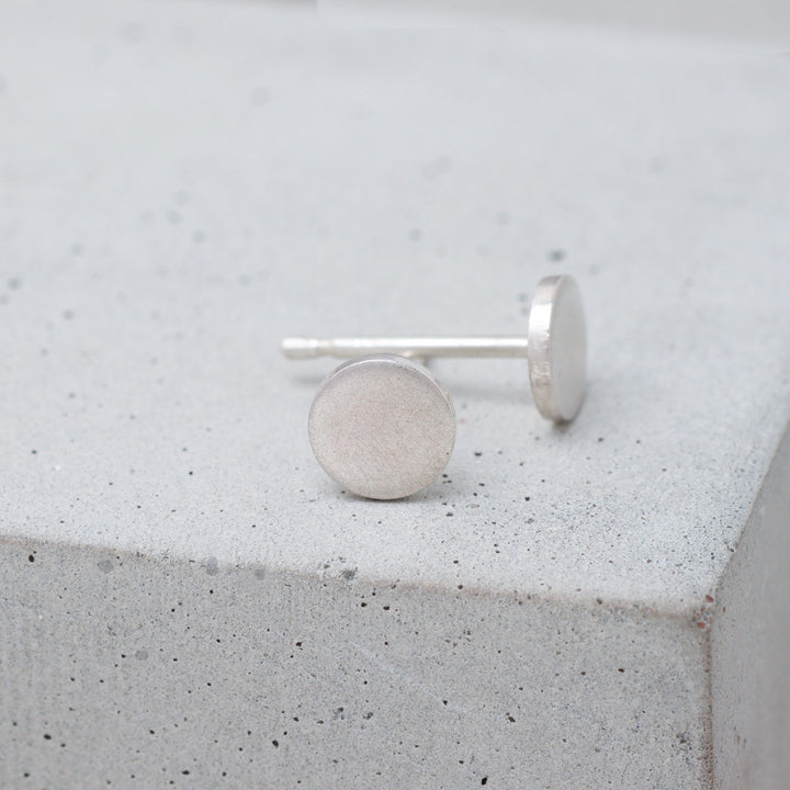Frosted sterling silver circle stud earrings side