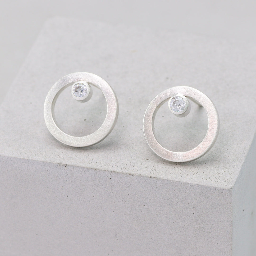 Frosted sterling silver circular stud earrings with moissanite 