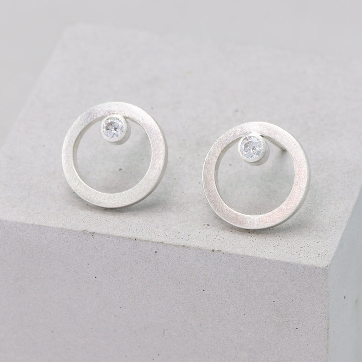 Frosted sterling silver circular stud earrings with moissanite 