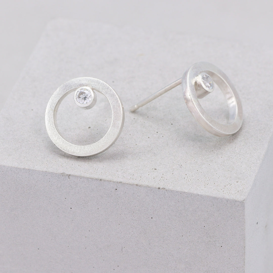Handmade frosted sterling silver circular stud earrings with moissanite 