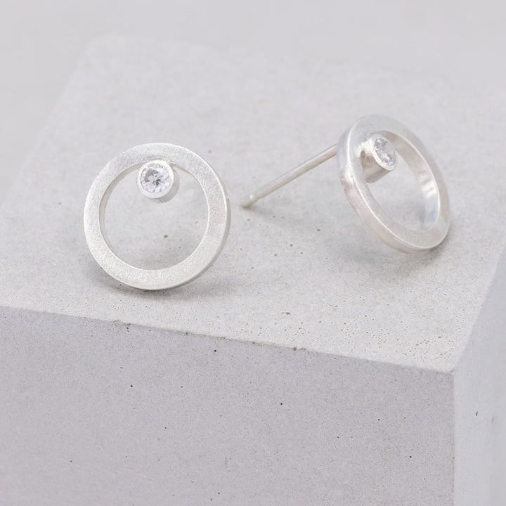 Handmade frosted sterling silver circular stud earrings with moissanite 