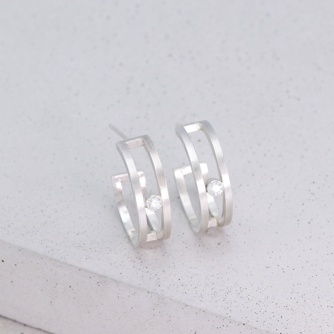 Pair of handmade sterling silver double hoop earrings with moissanite