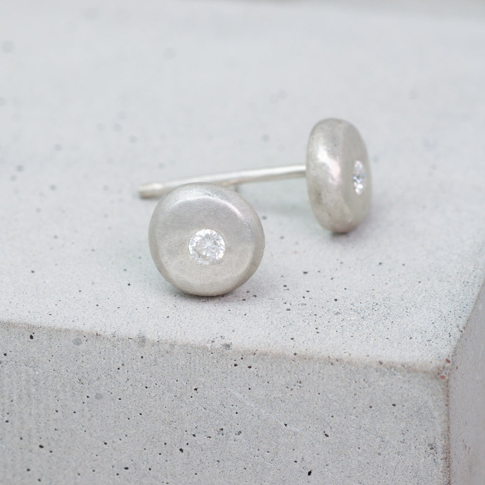 Recycled sterling silver pebble stud earrings set with moissanite side