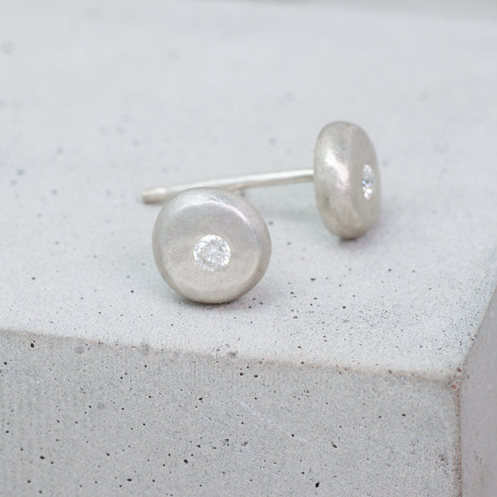 Recycled sterling silver pebble stud earrings set with moissanite side