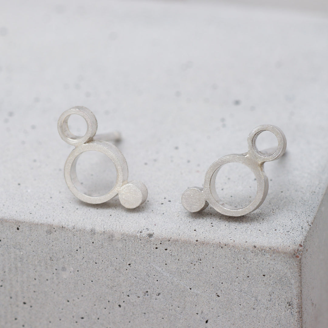 Sterling silver geometric circle stud earrings with frosted finish