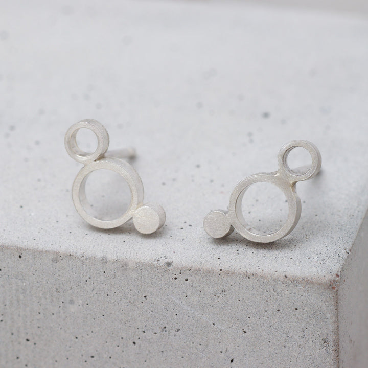Sterling silver geometric circle stud earrings with frosted finish