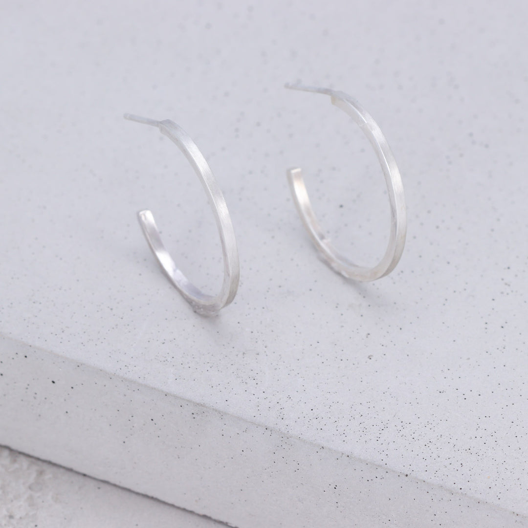 Handmade large sterling silver hoop earrings with brushed and polished finish