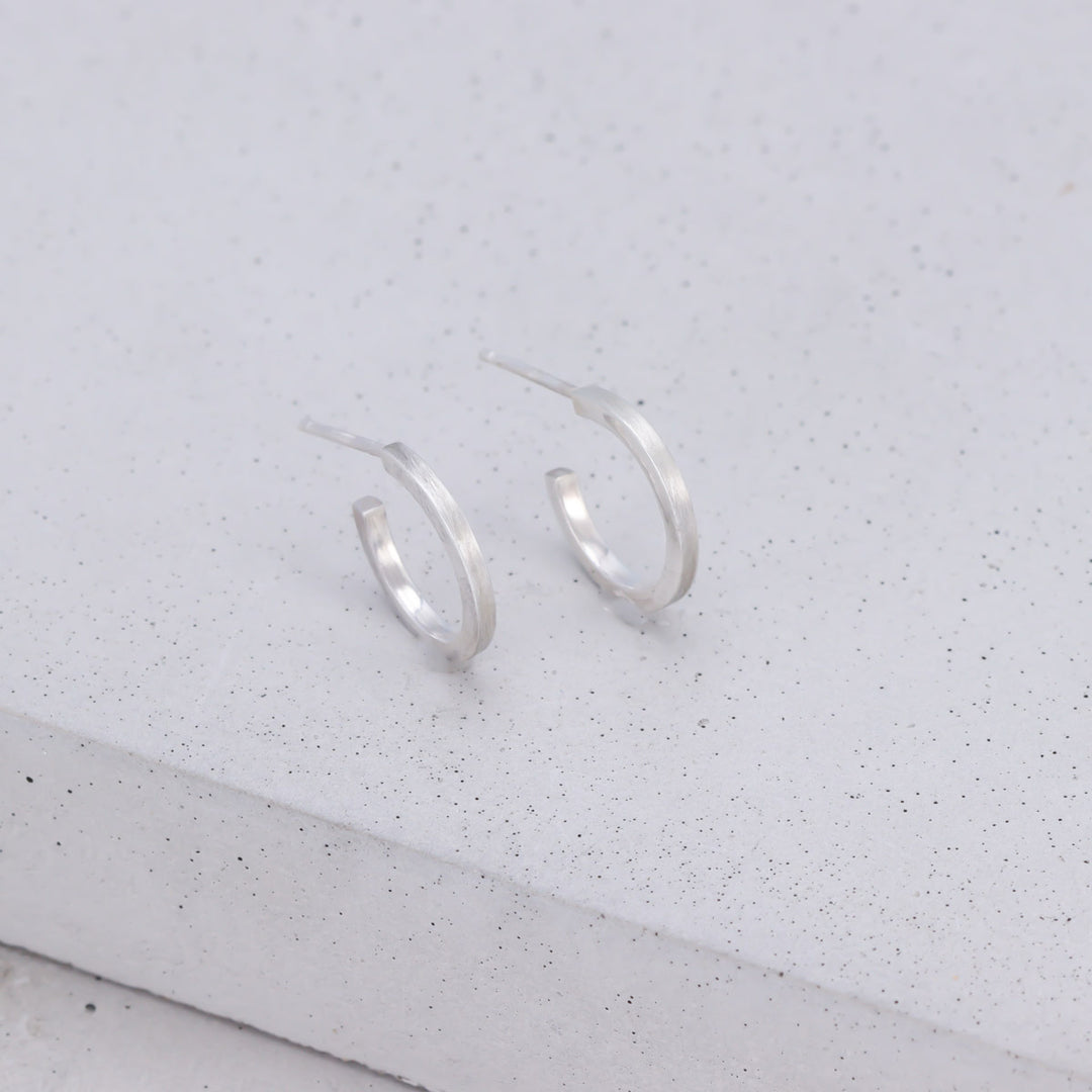 Handmade small sterling silver hoop earrings with brushed and polished finish