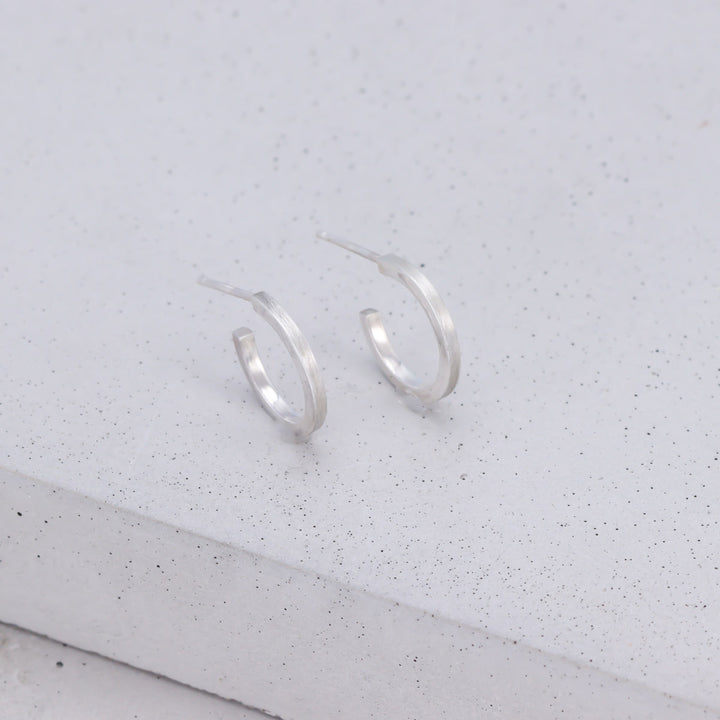 Handmade small sterling silver hoop earrings with brushed and polished finish