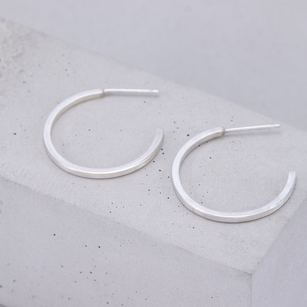 Large brushed sterling silver hoop earrings handmade by Ruth Sims Jewellery