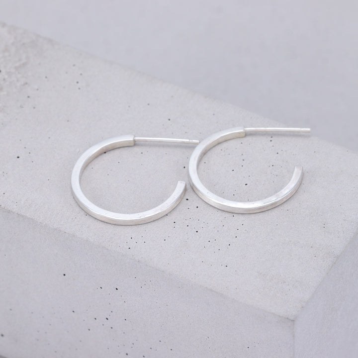 Medium brushed sterling silver hoop earrings handmade by Ruth Sims Jewellery
