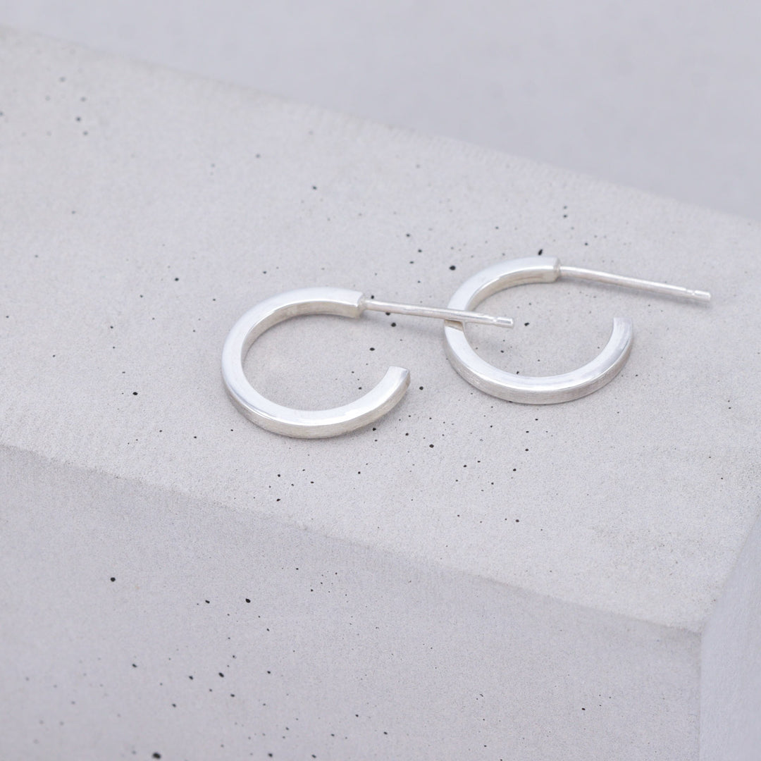 Small brushed sterling silver hoop earrings handmade by Ruth Sims Jewellery