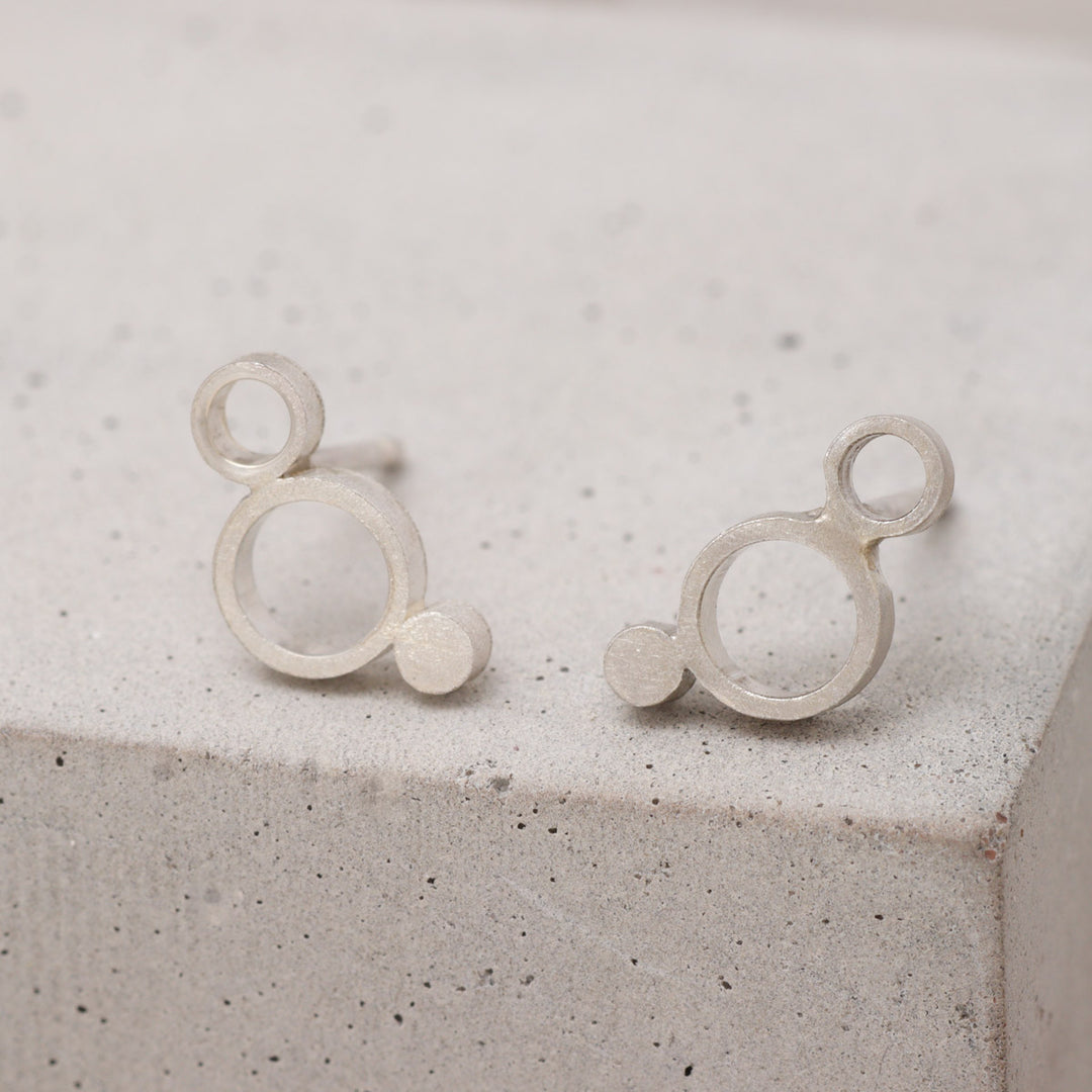 Sterling silver geometric circle stud earrings with frosted finish