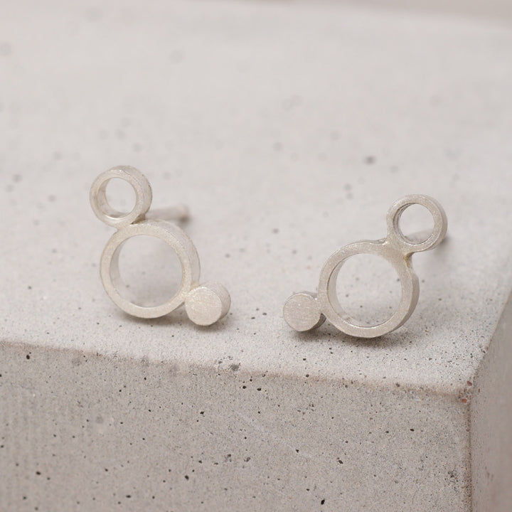 Sterling silver geometric circle stud earrings with frosted finish